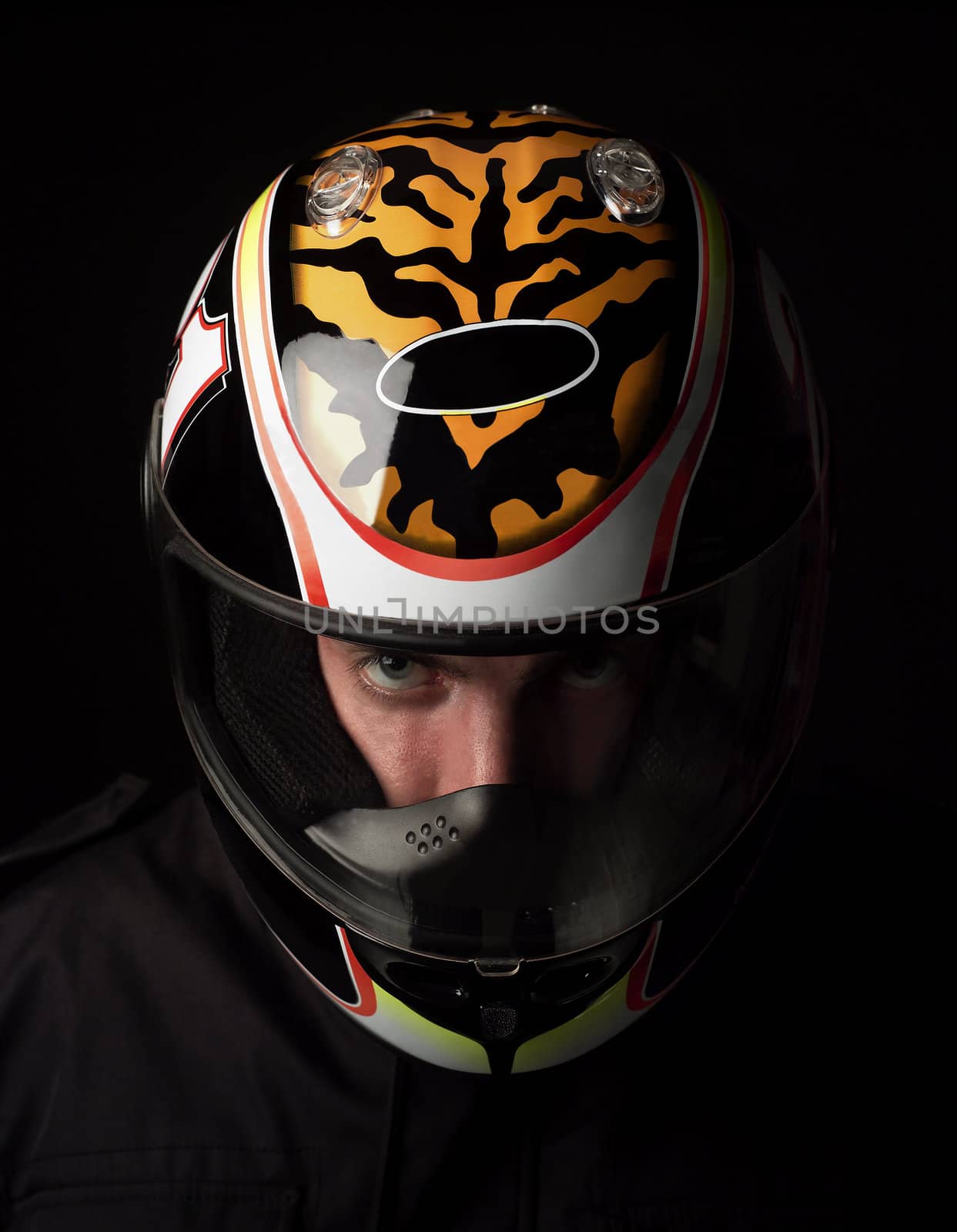 Man with motorcycle helmet on black background