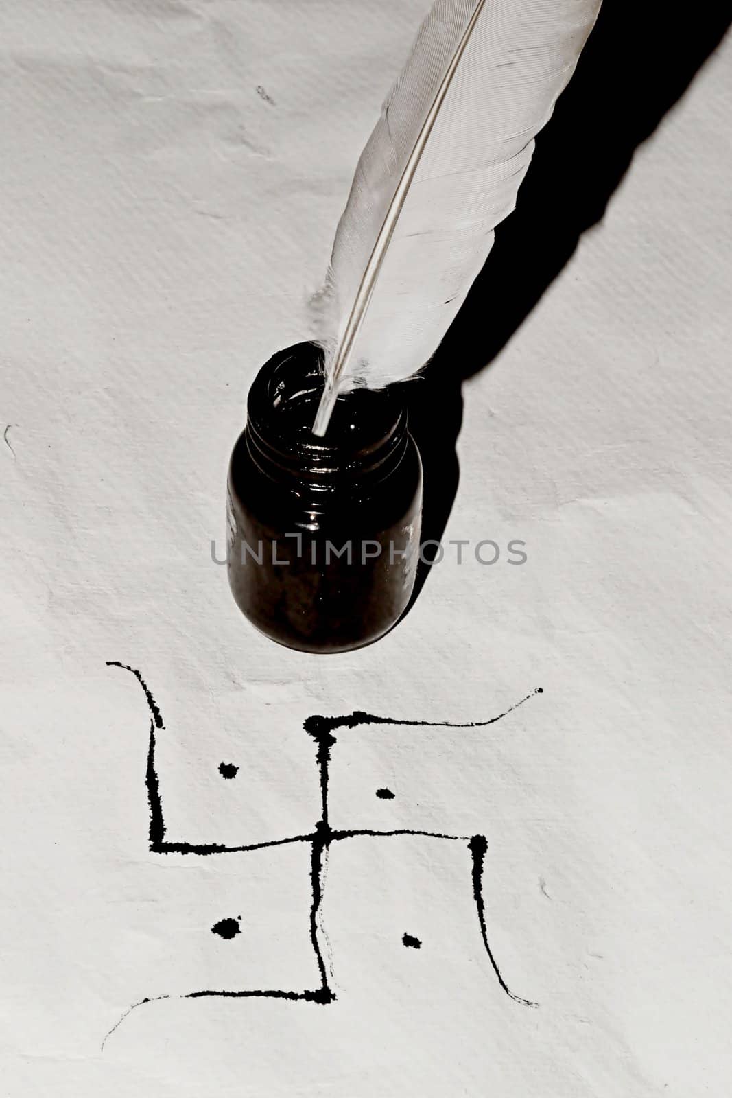 Traditional Swastik  with feather and ink bottle