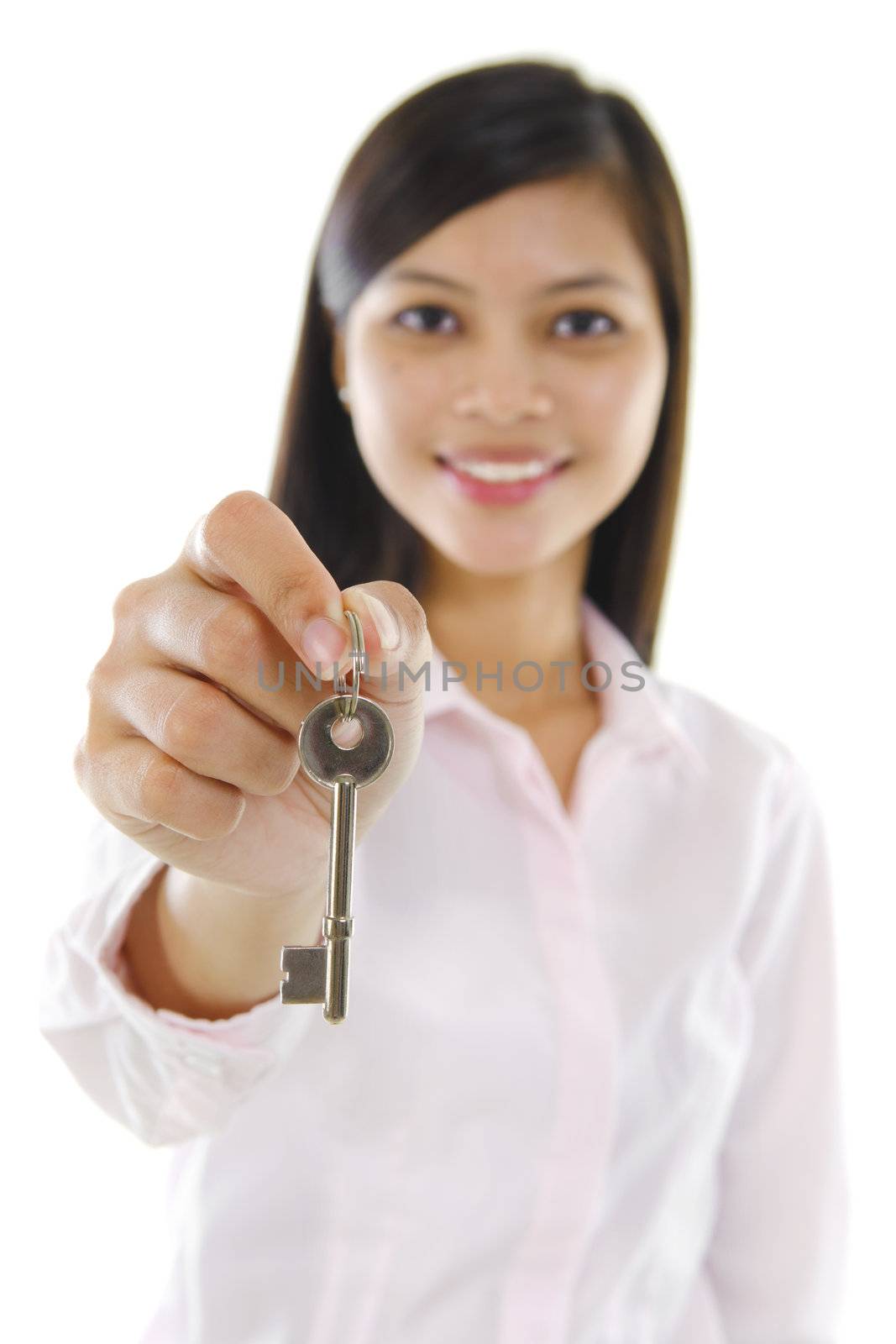 Mixed race sales woman holding key against white background.