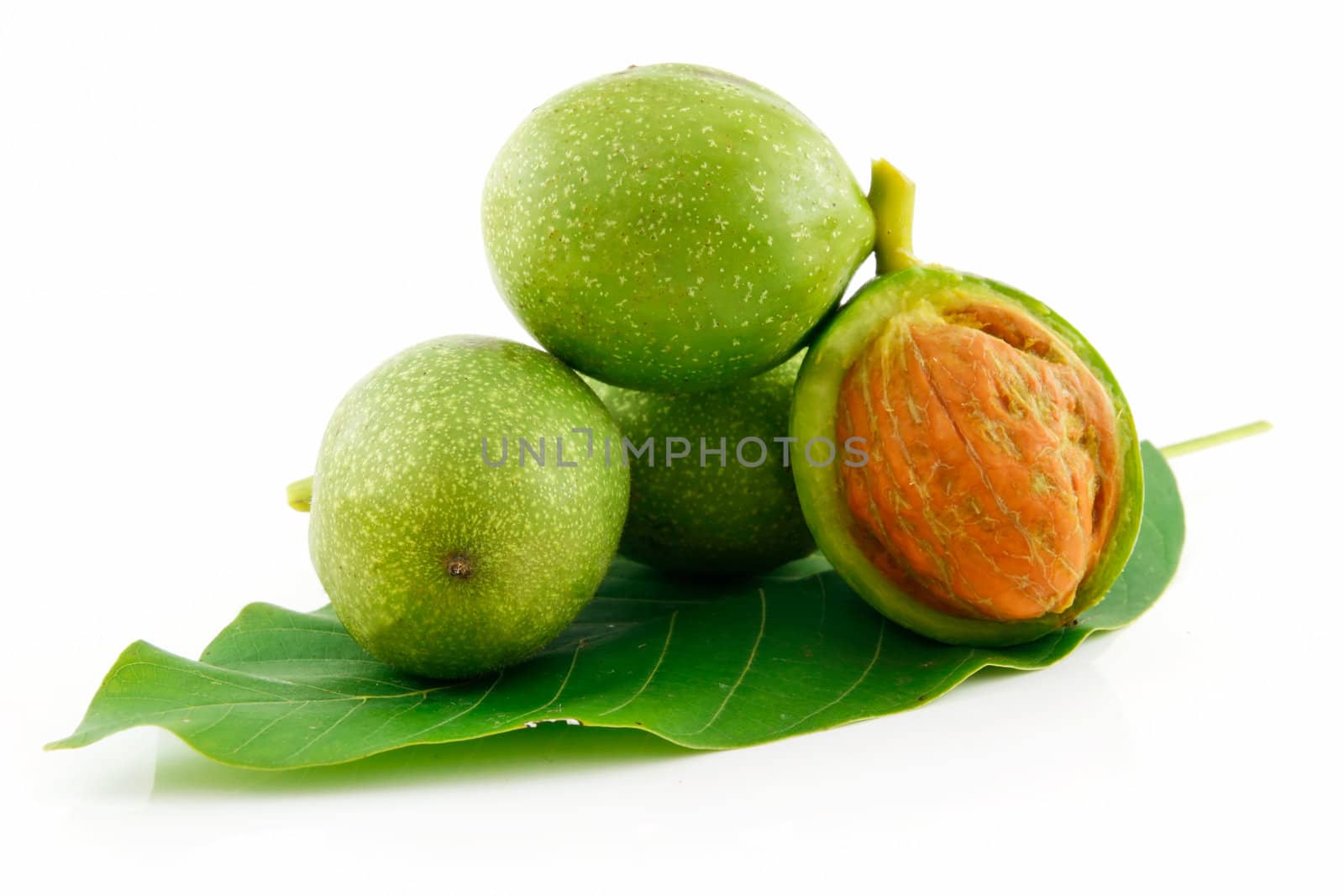 Ripe Broken Walnuts with Green Leaves Isolated on White Background