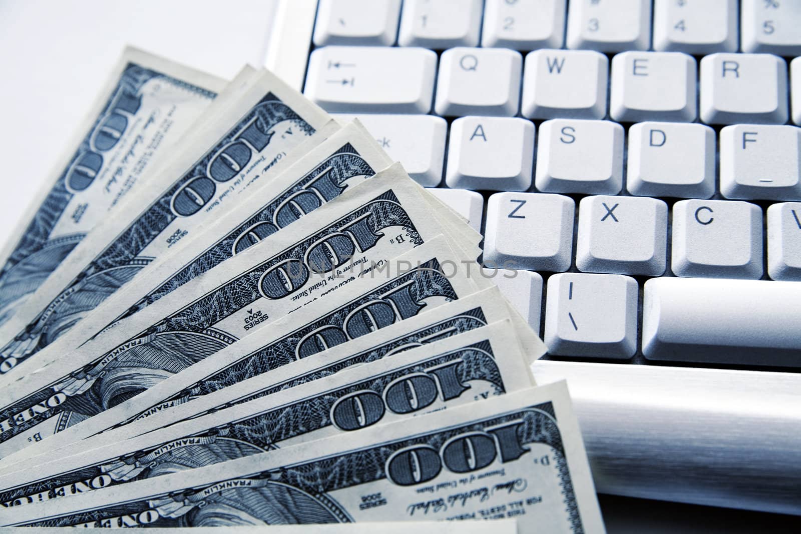 dollar banknotes on a background an aluminium computer keyboard