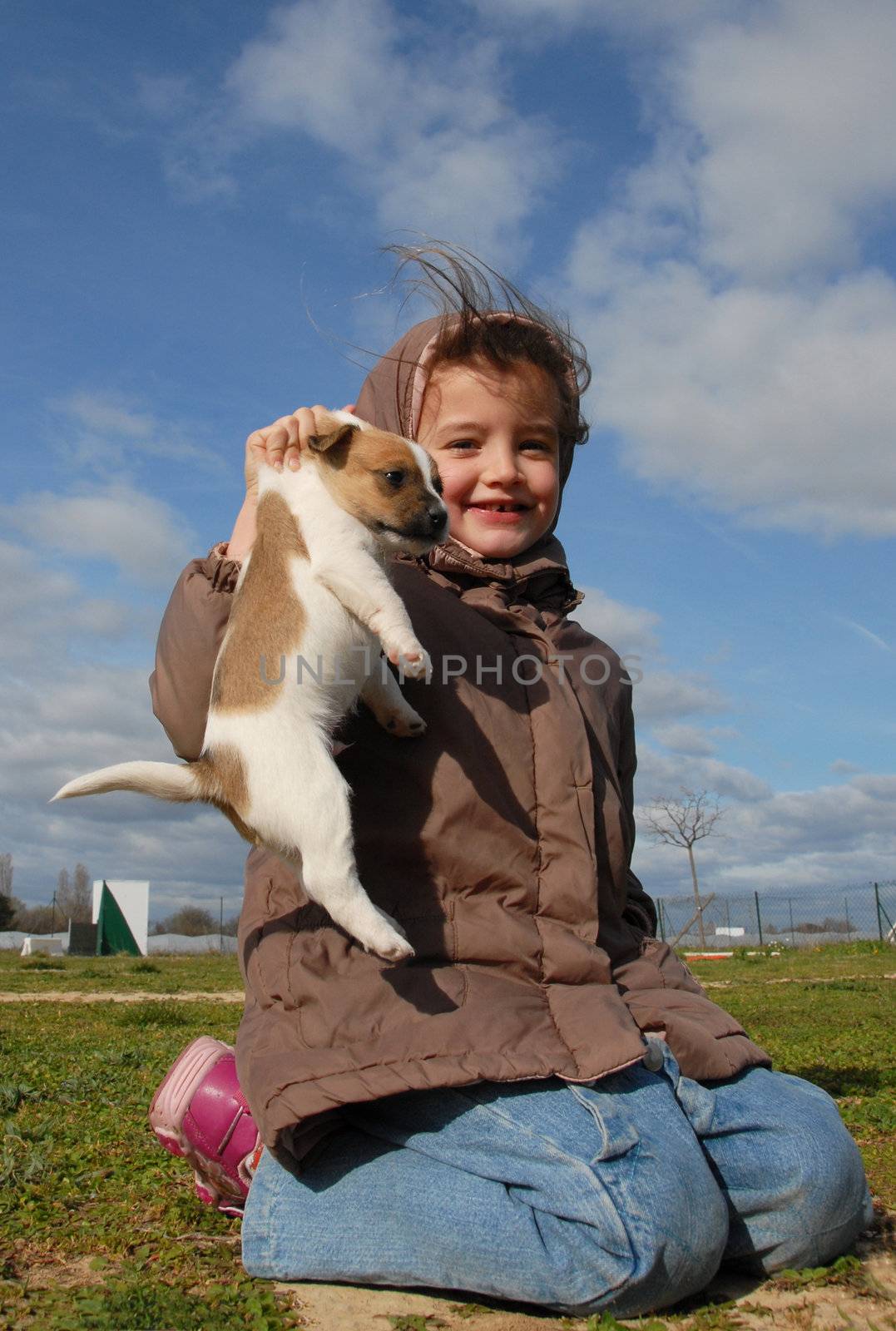 little girl and her young puppy purebred jack russel terrier
