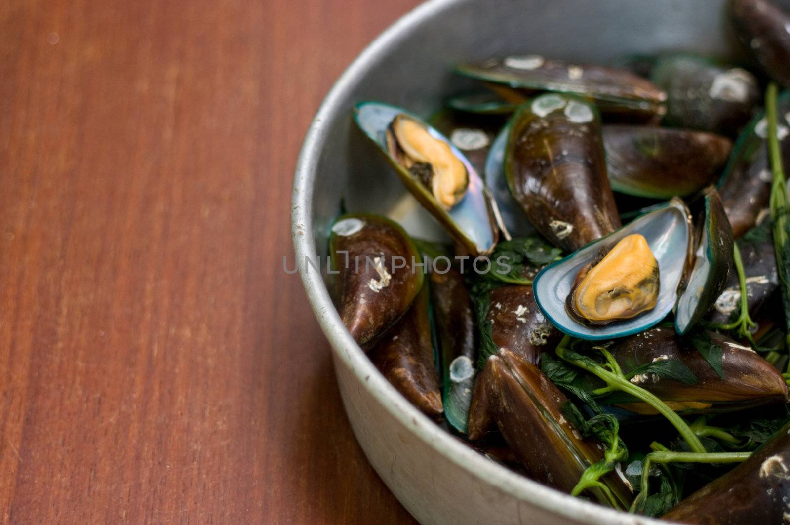 Boiled Asian green mussel on wooden table