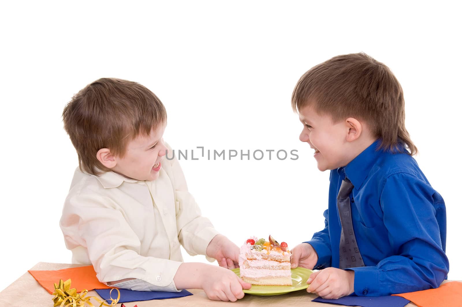 Two boys share a piece of cake on white background