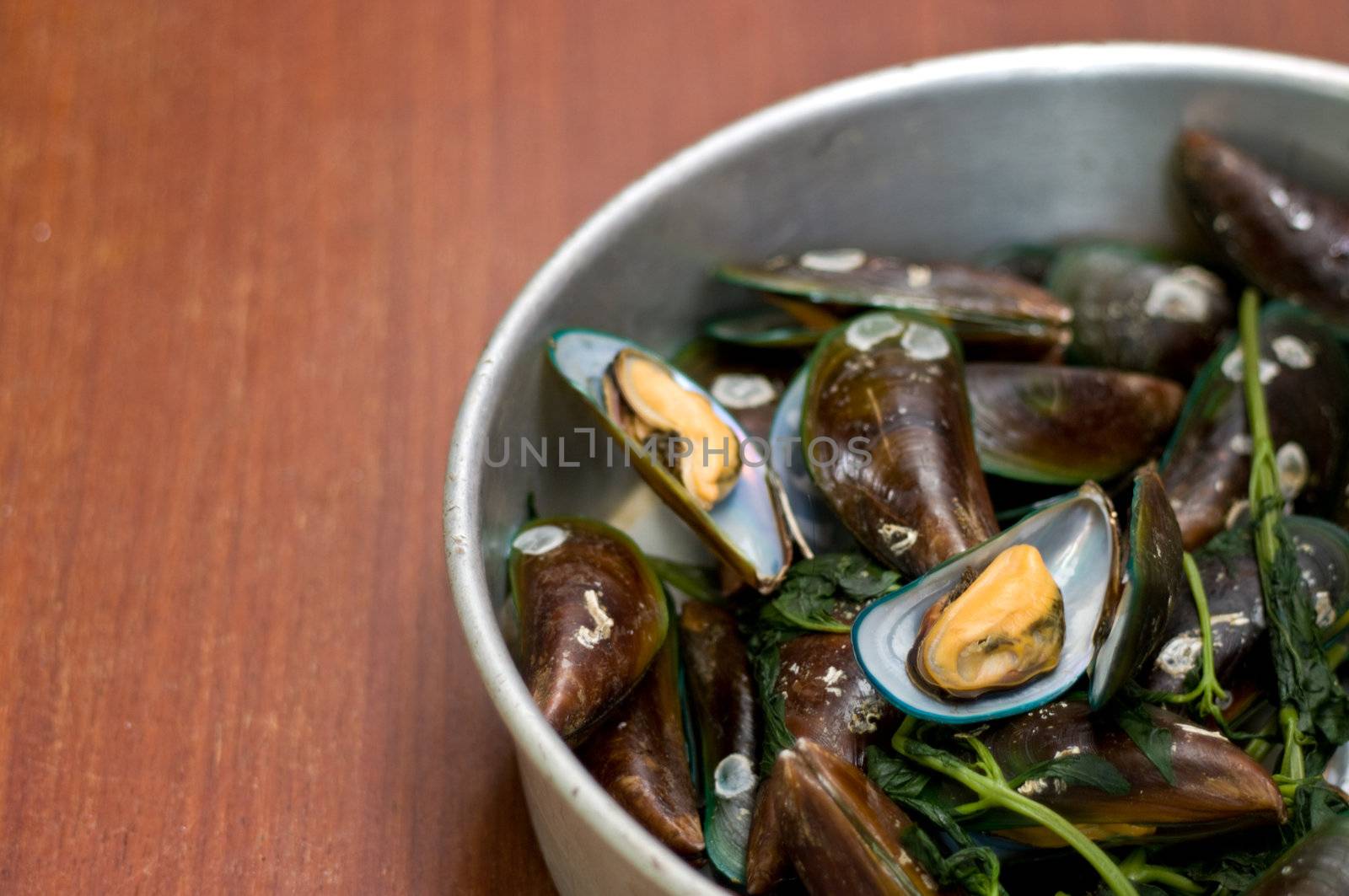 Boiled Asian green mussel on wooden table