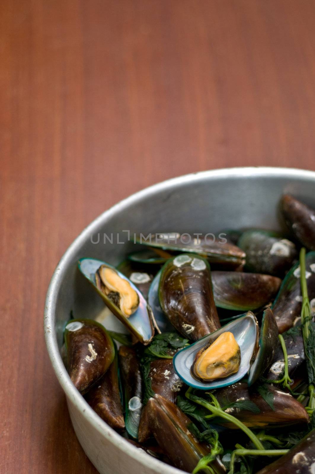 Boiled Asian green mussel on wooden table