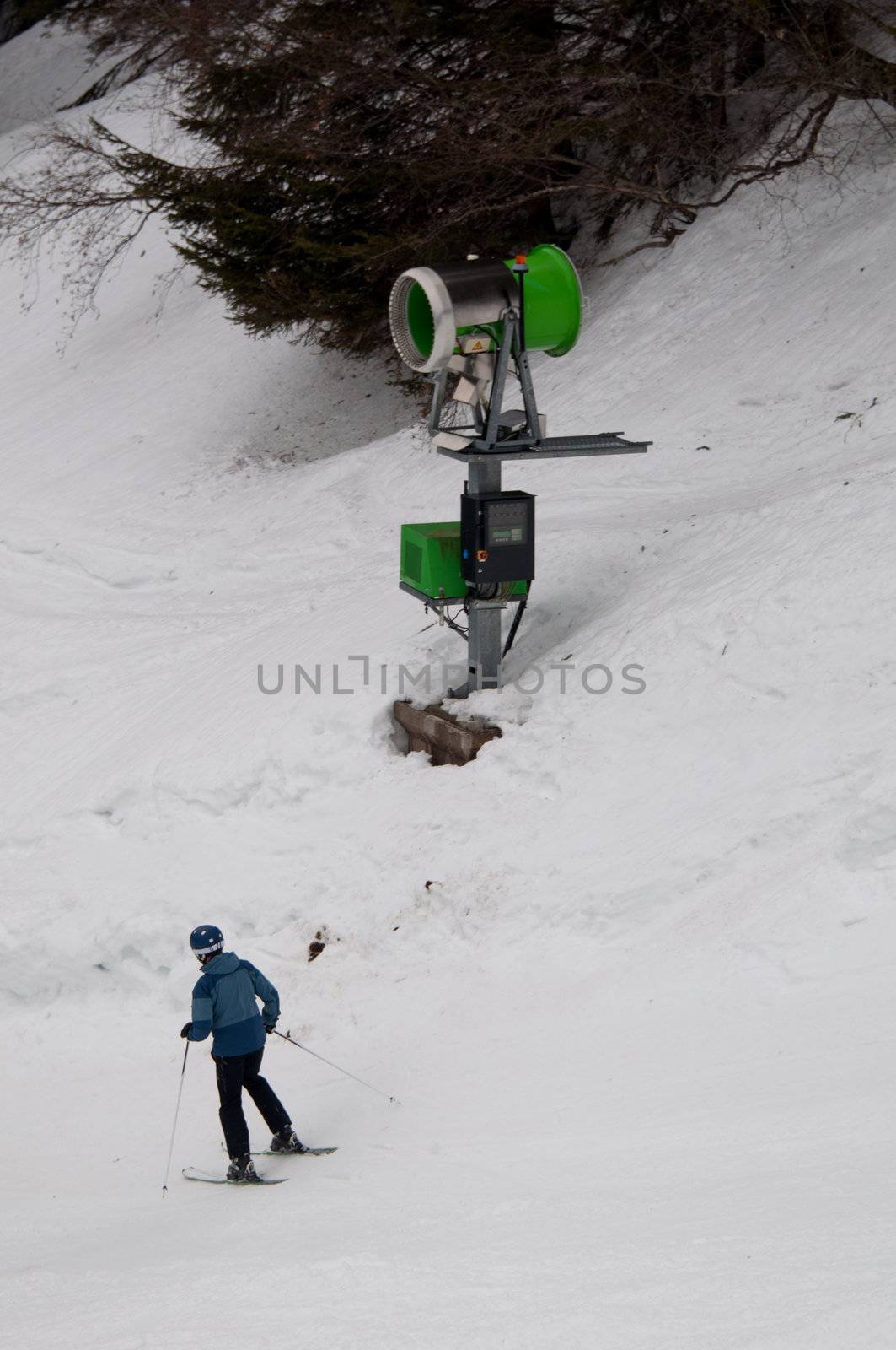 skier passing a snowgun/snow cannon in Montafon, Austria