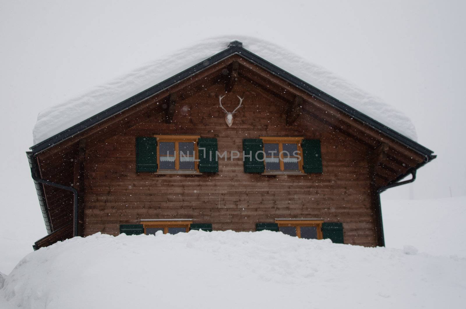 Wooden skiing hut covered with a lot of fresh snow in Montafon, Austria