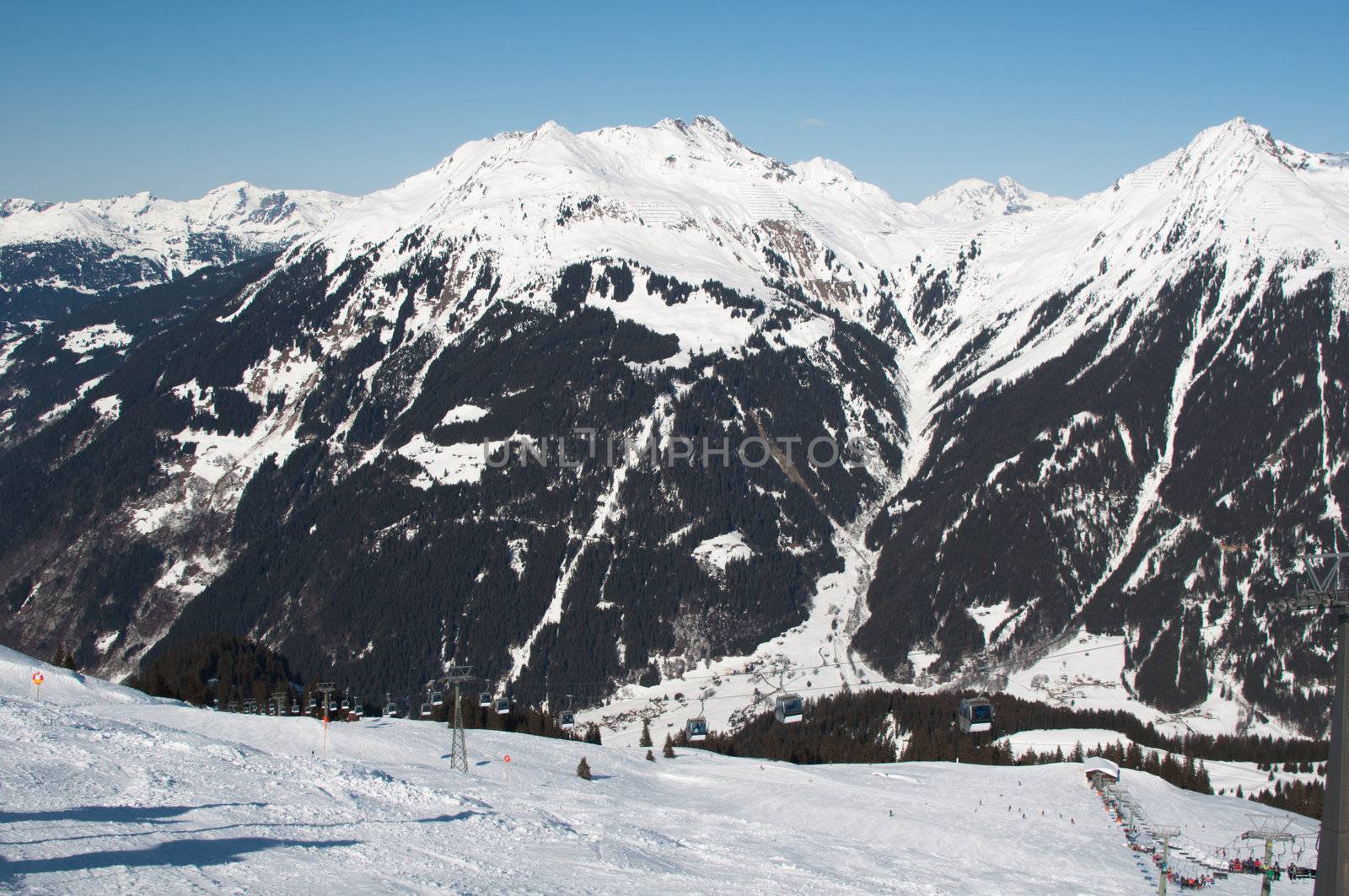 cabins of a cable car lift in front of mountains in Montafon, Austria