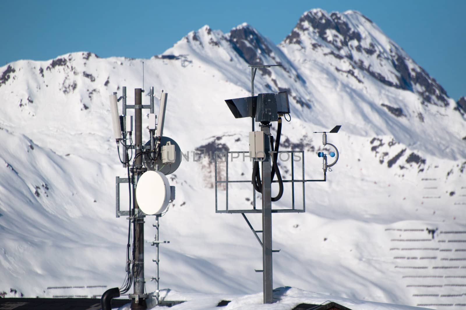 Communication tower with lifecam, satellite dishes and aerials in skiing resort in Montafon, Austria