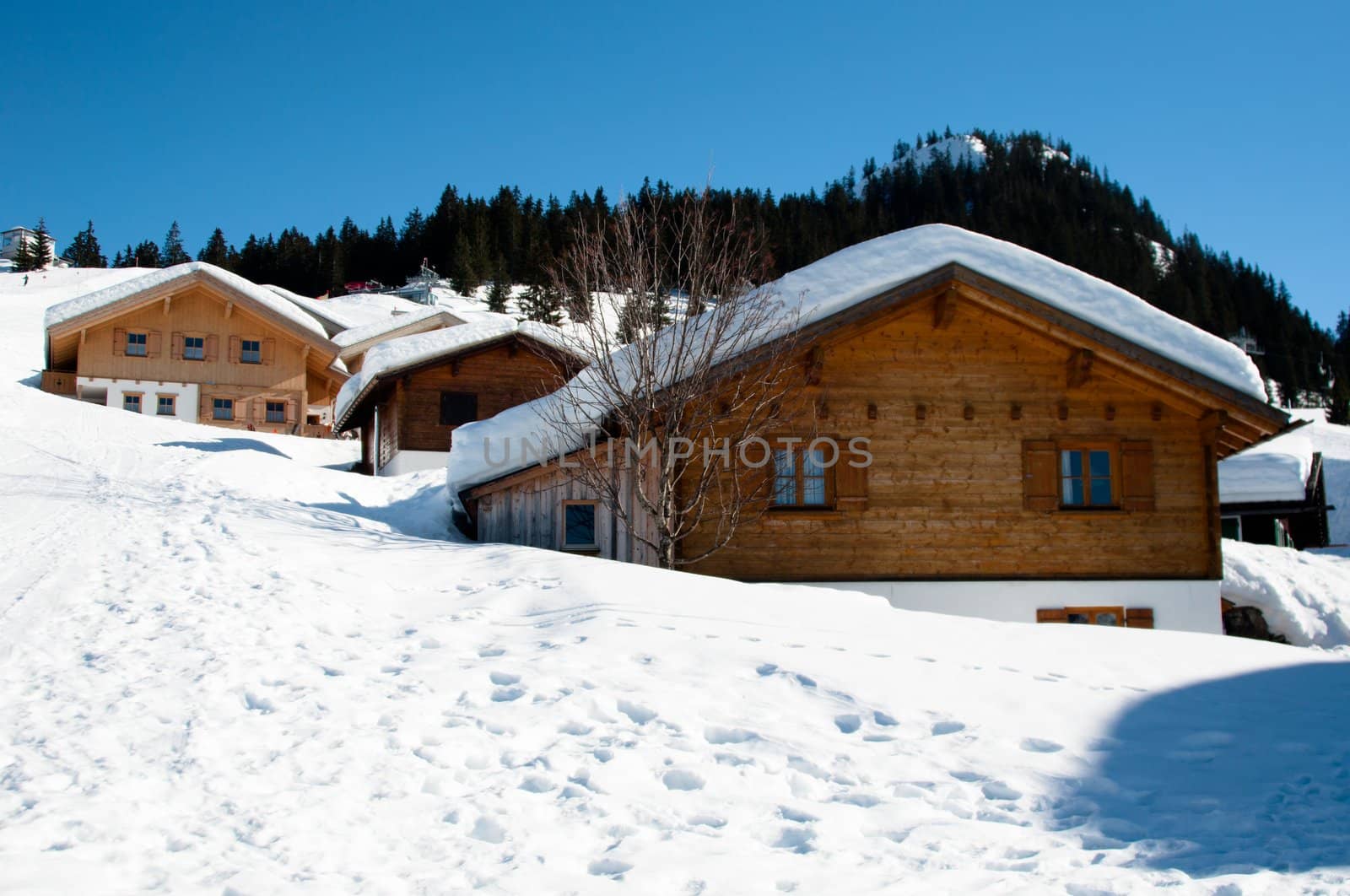 Wooden skiing huts covered with a lot of fresh snow in Montafon, Austria