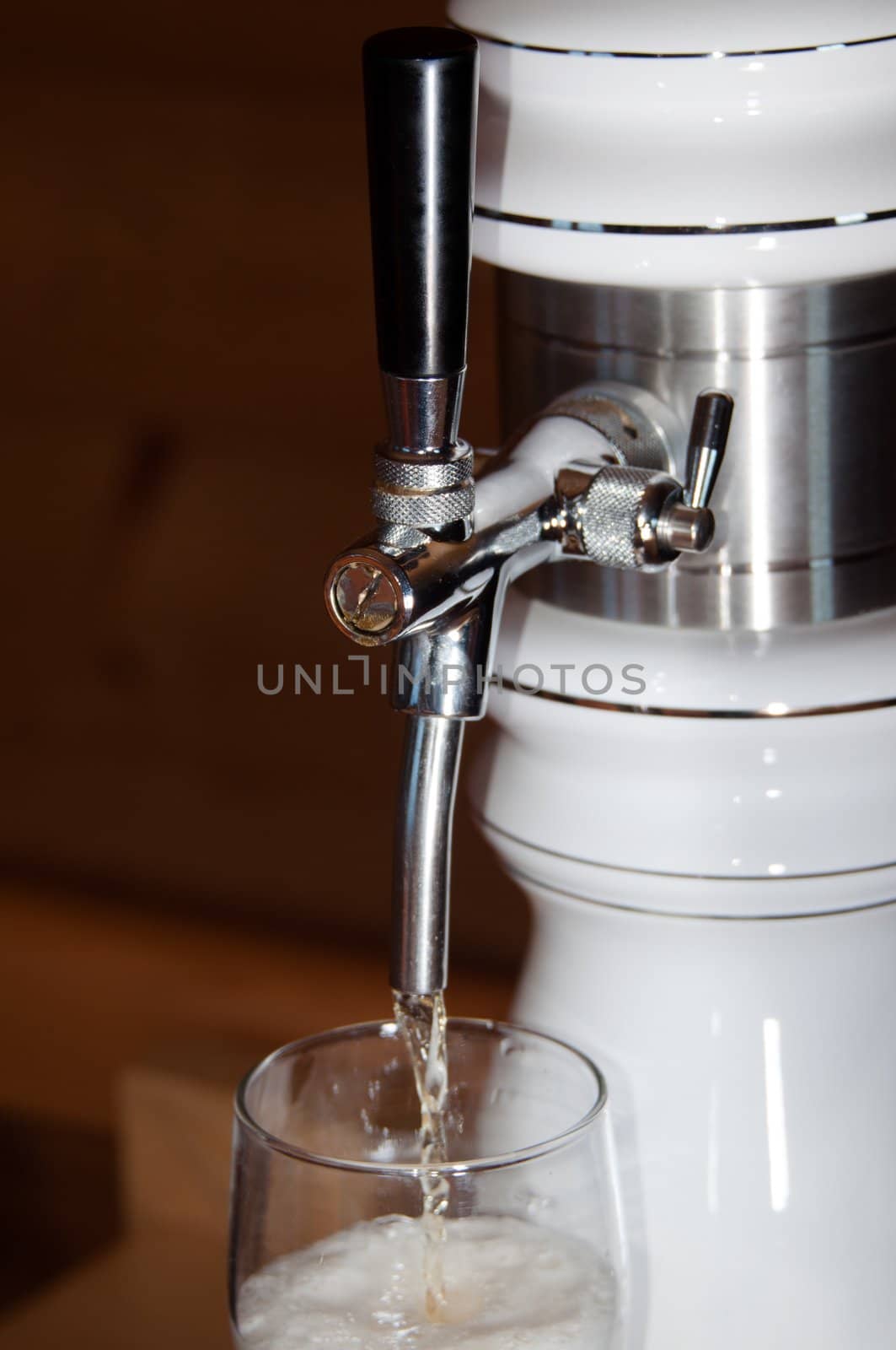closeup of fresh beer pouring from a tap