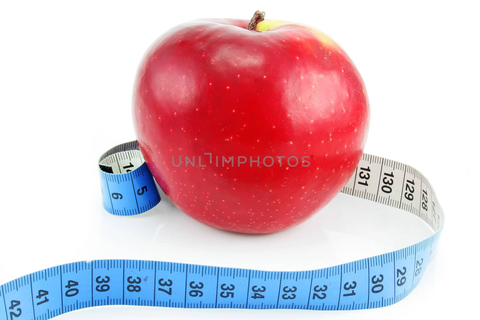 Bright red apple and measuring tape isolated on a white background