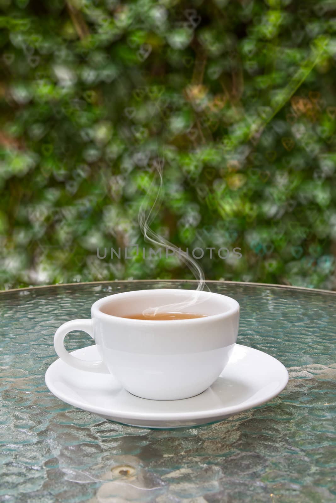cup of tea on glass table by tungphoto