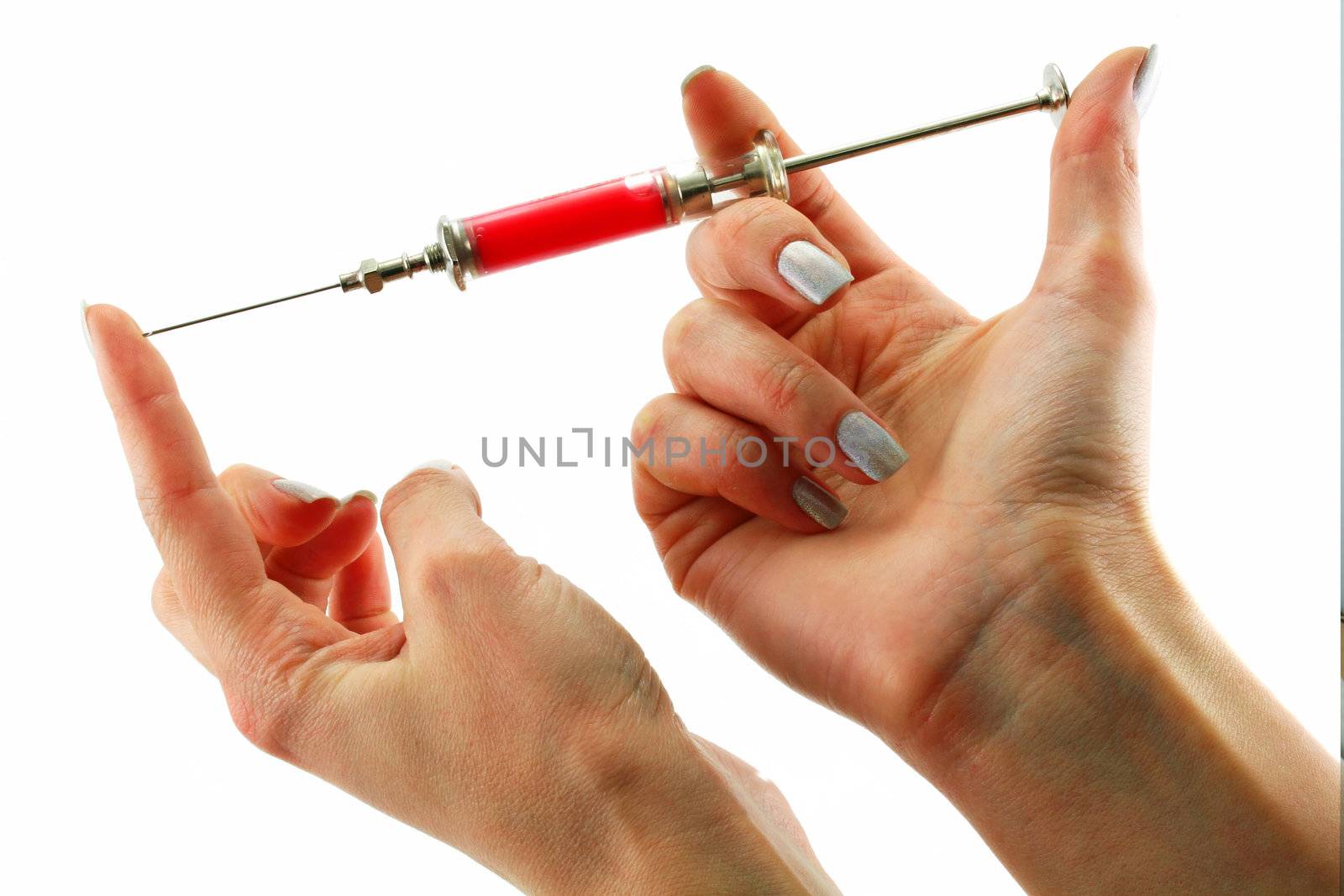 Reusable syringe full of acid substance in hands isolated on a white background