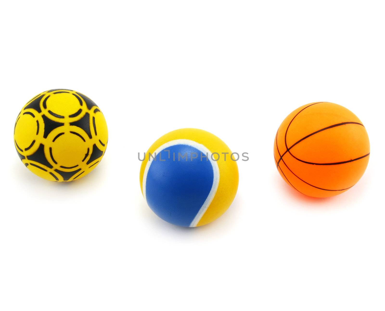 Three plastic colored balls (for playing handball, tennis, basketball) isolated on a white background