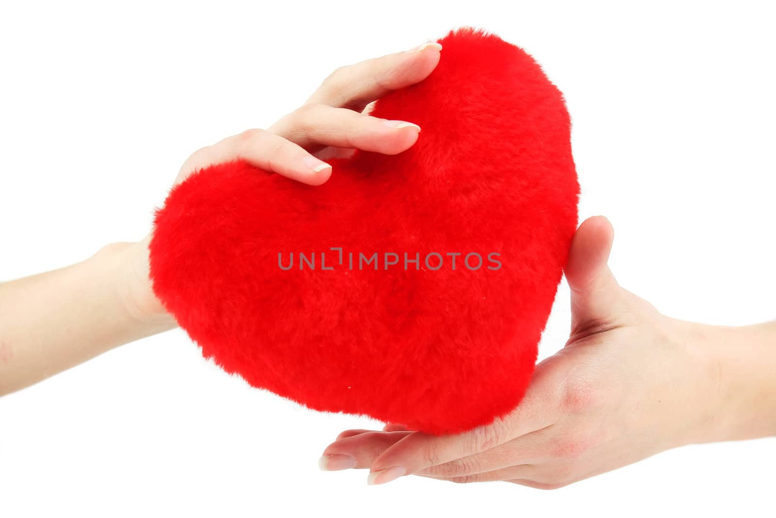 Close-up of red wooden heart in female hands by alphacell