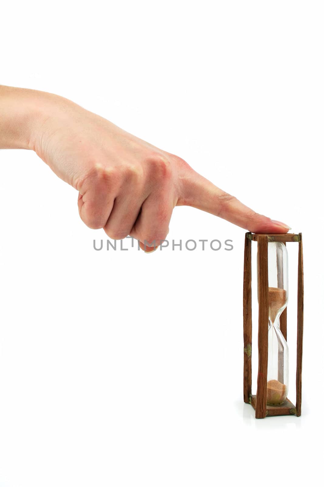 Female hand denotes hourglass isolated on a white background
