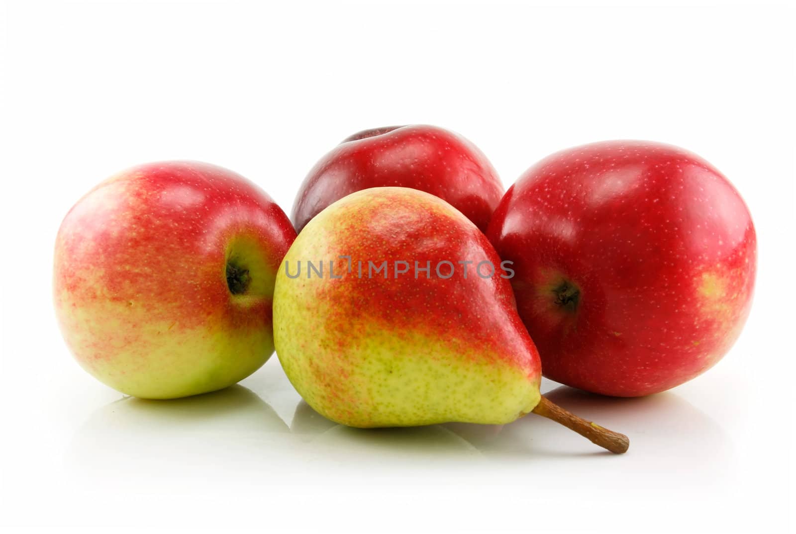 Three Ripe Red Apples and Pear in Row Isolated on White Background