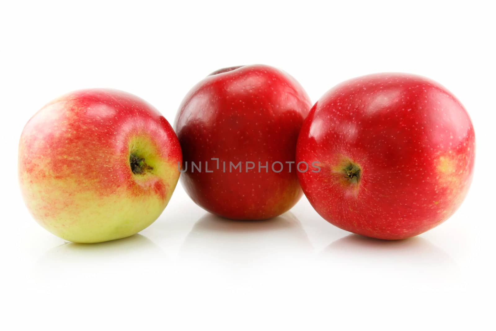 Three Ripe Red Apples in Row Isolated on White Background