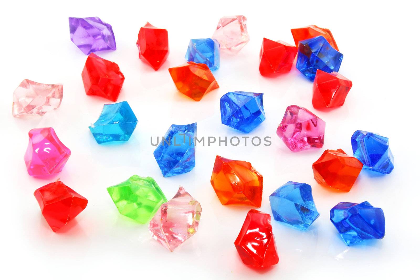 Colored assorted gemstones isolated on a white background
