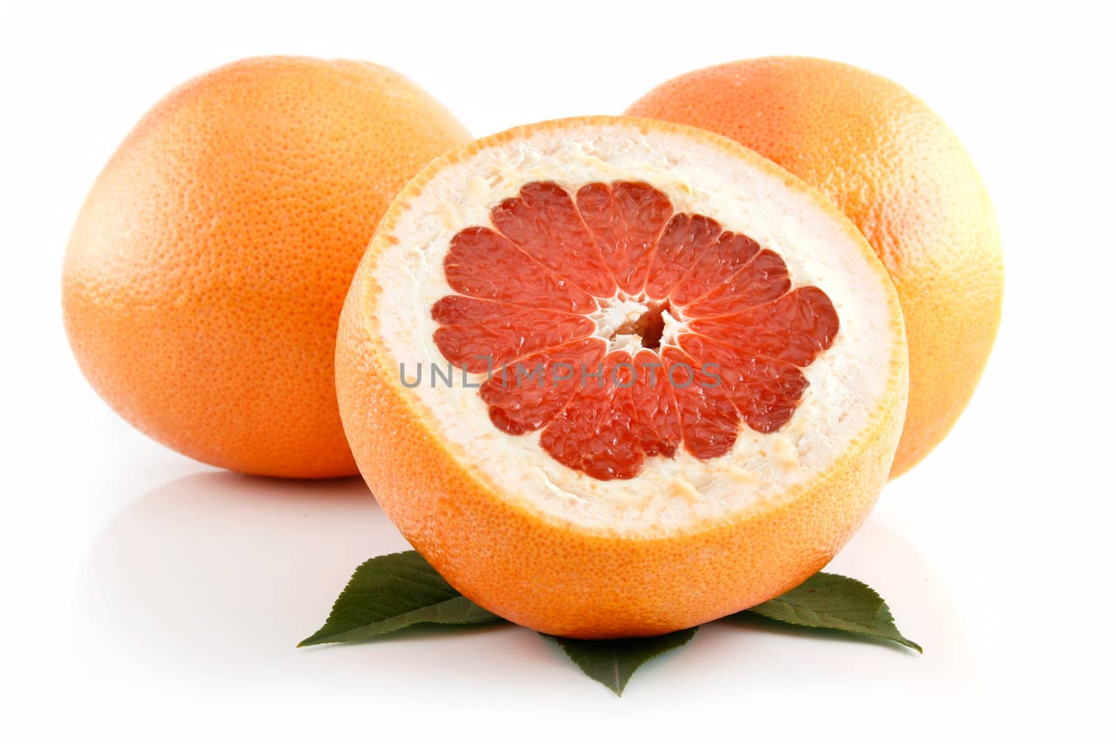 Ripe Sliced Grapefruit with Leaves Isolated on White Background