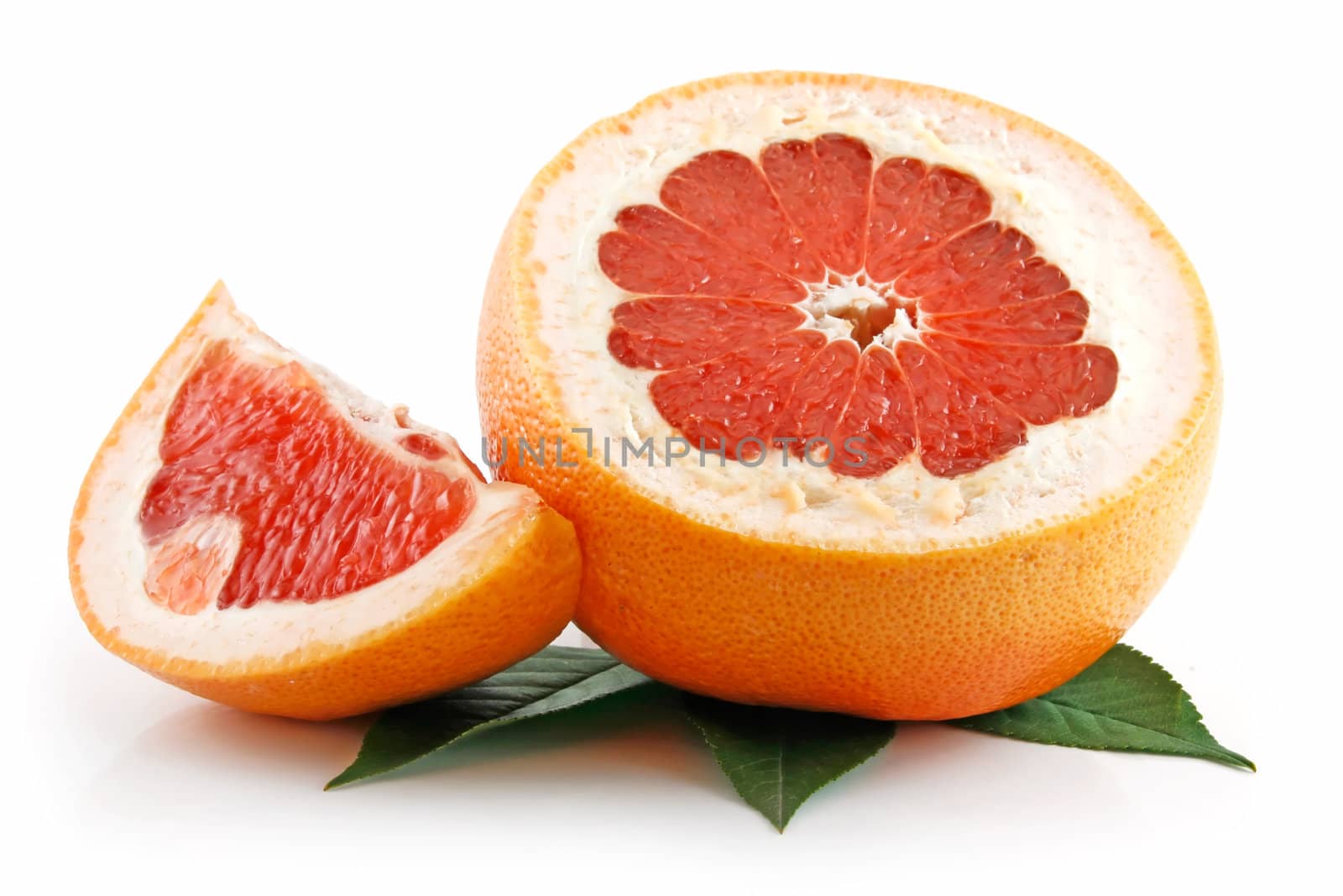 Ripe Sliced Grapefruit with Leaves Isolated on White Background