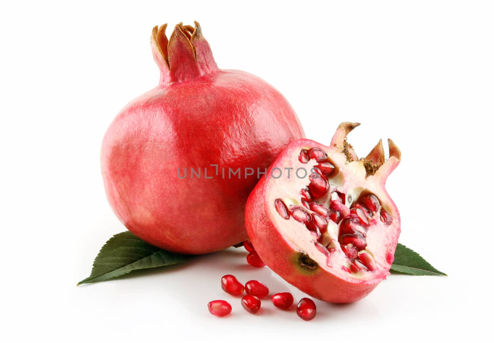 Ripe Sliced Pomegranate Fruit with Seeds Isolated on White Background
