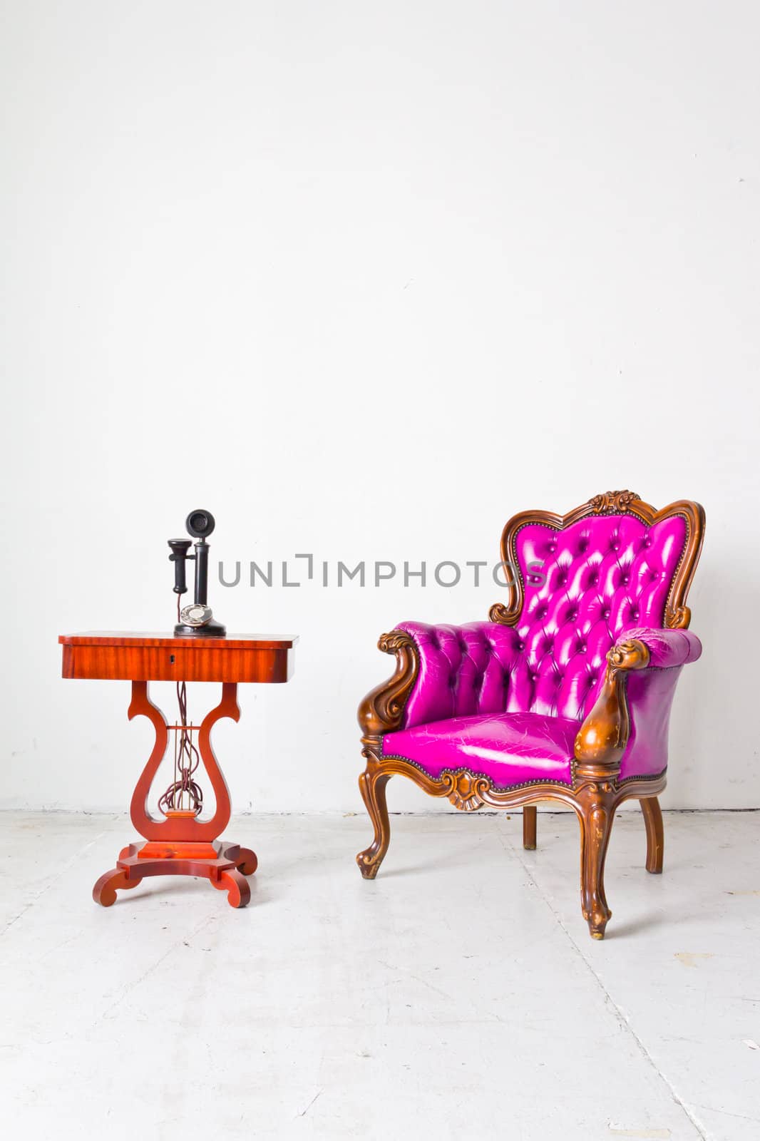 vintage luxury armchair and telephone in white room by tungphoto