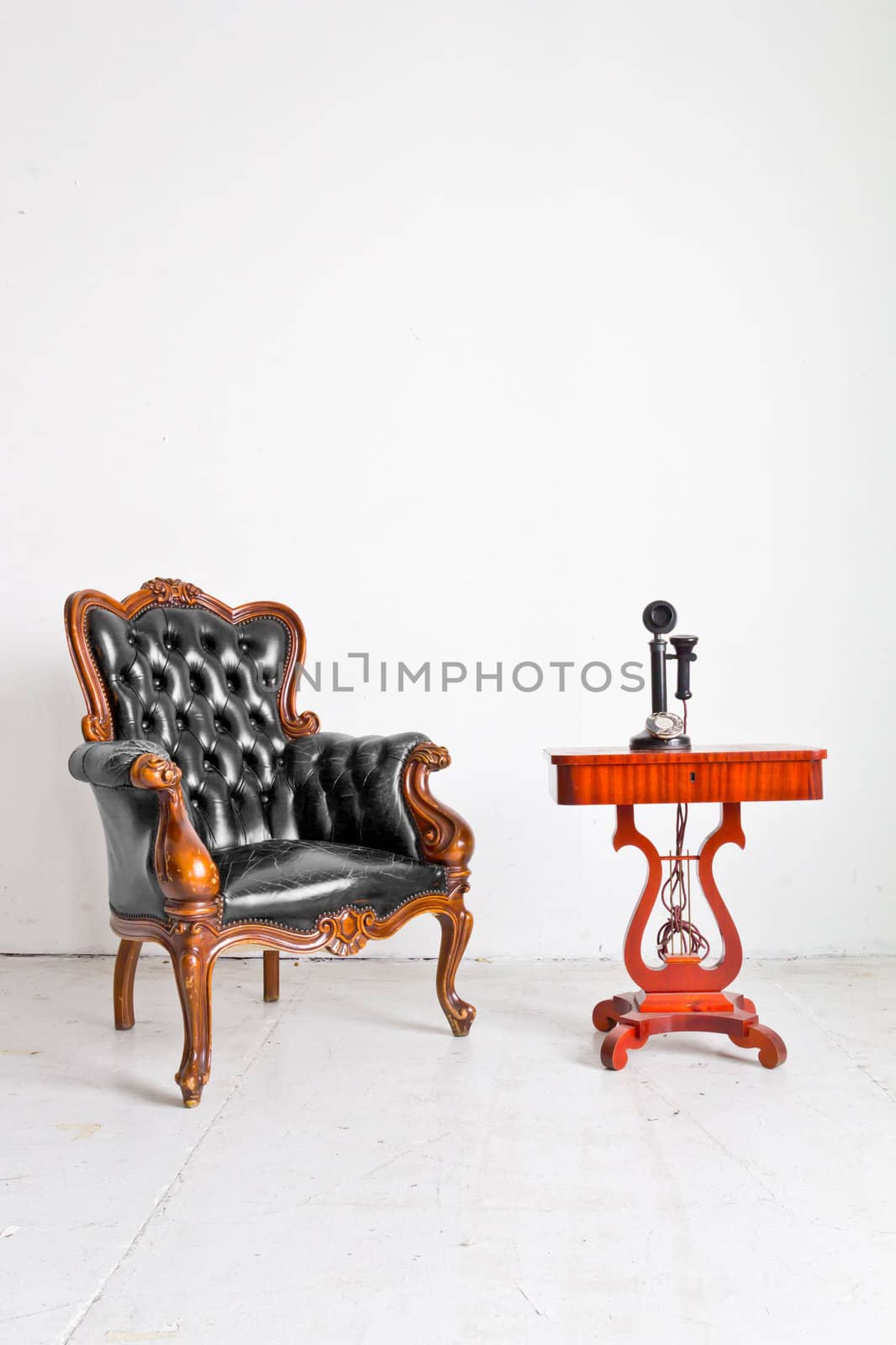 vintage luxury armchair and telephone in white room