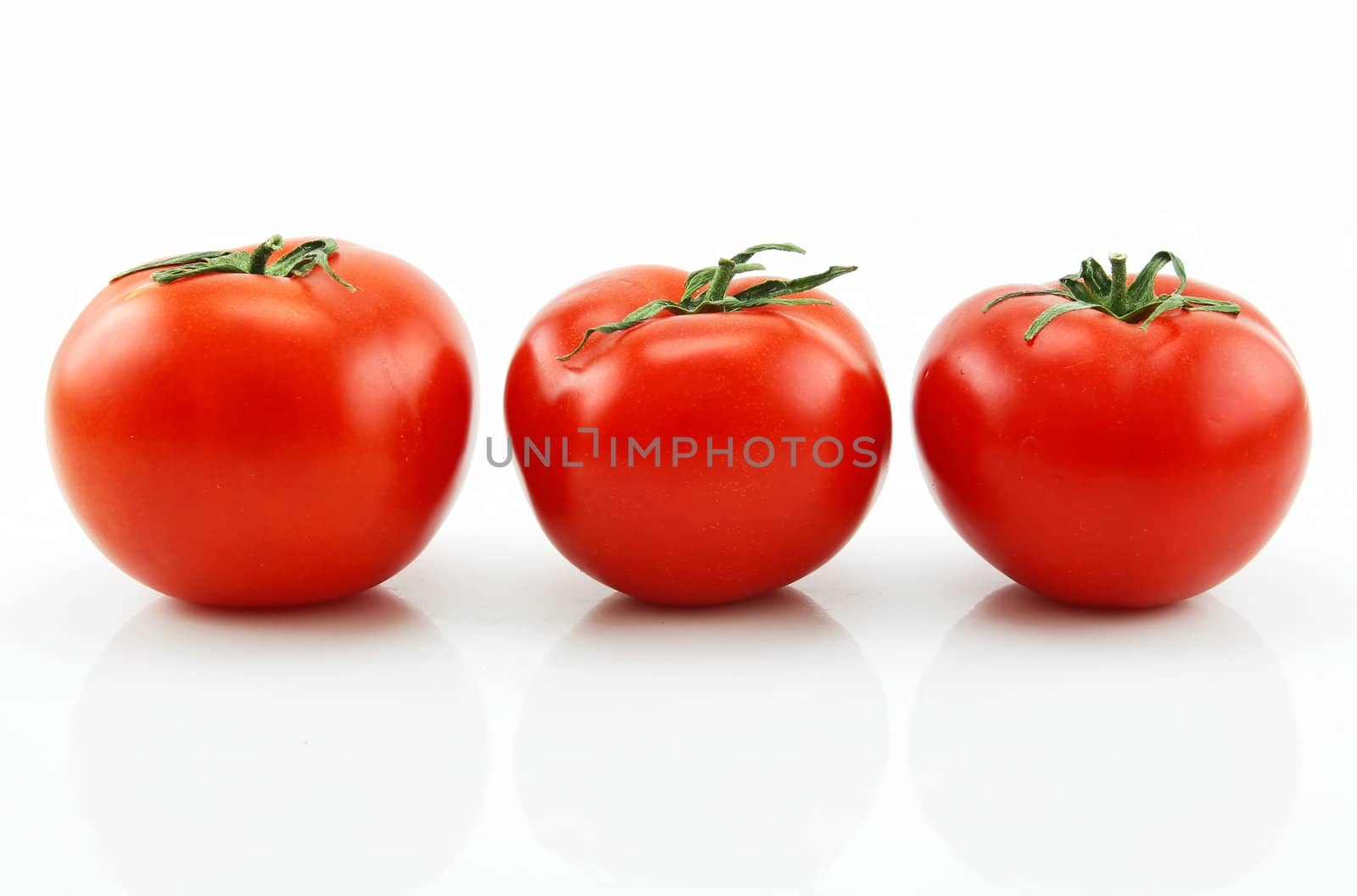 Three Ripe Tomatoes Isolated on White Background