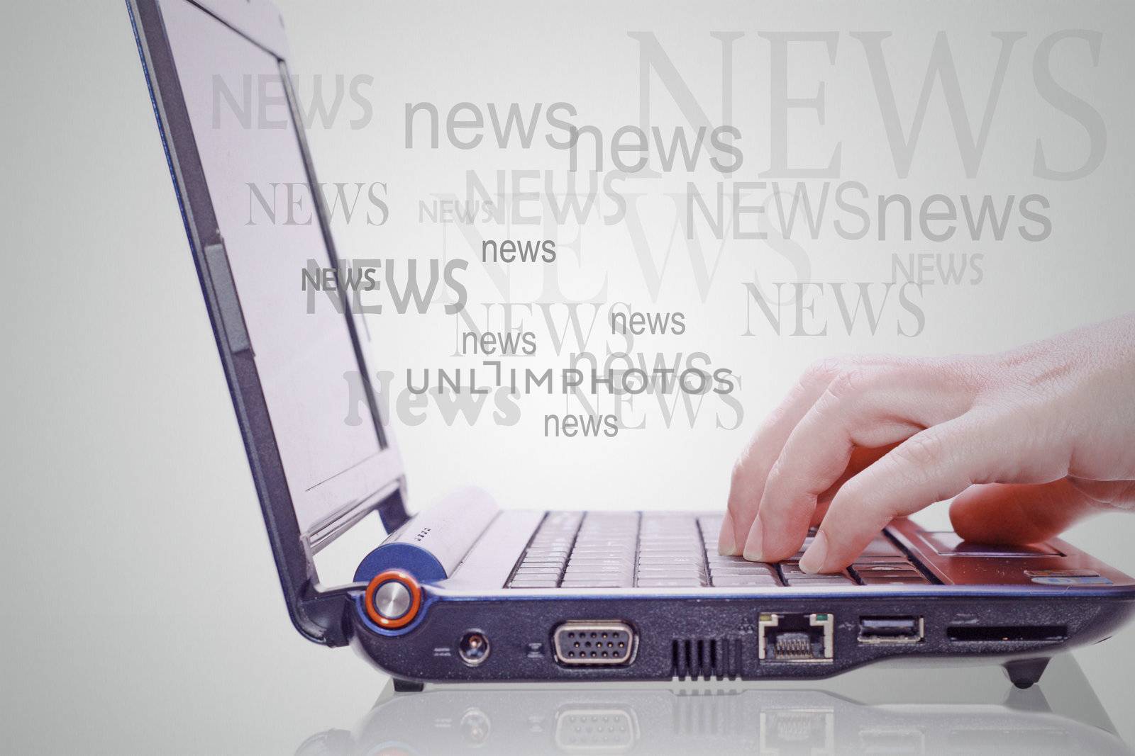 Image of hand on the laptop keyboard with the word news out of the screen.