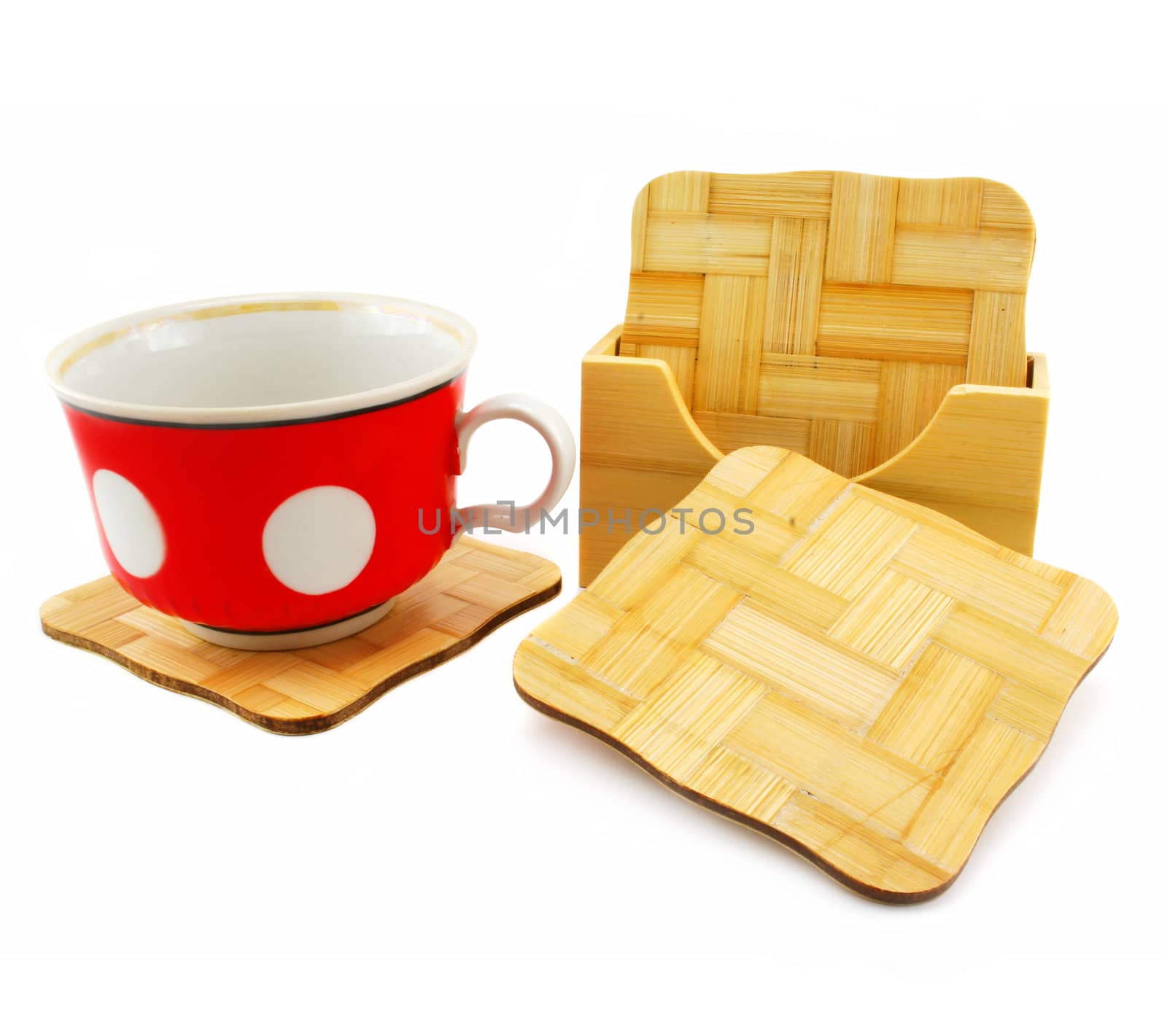 Colored cup and set of wooden trivets isolated on a white background