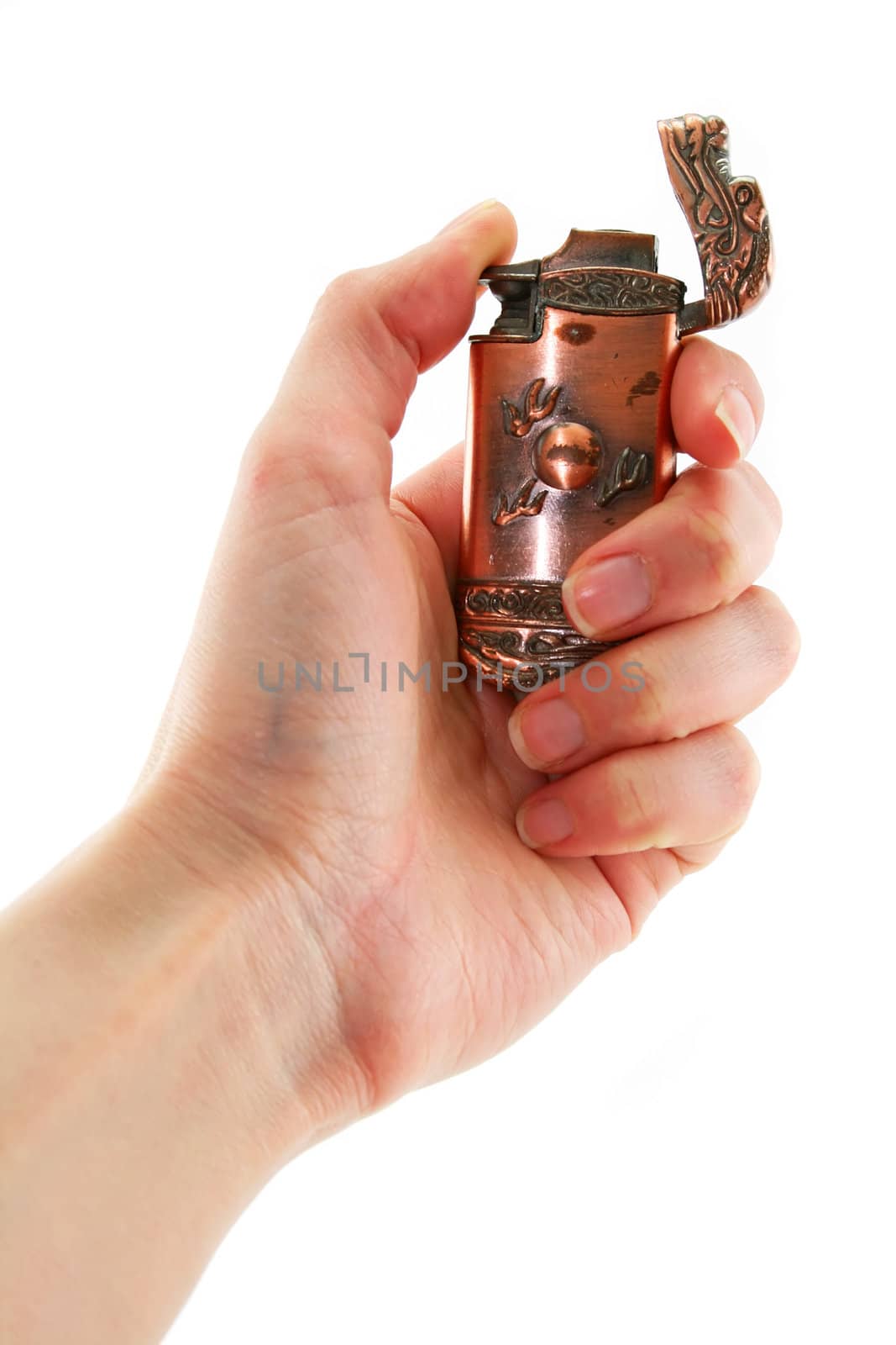 Female hand holds old bronze gas lighter by alphacell