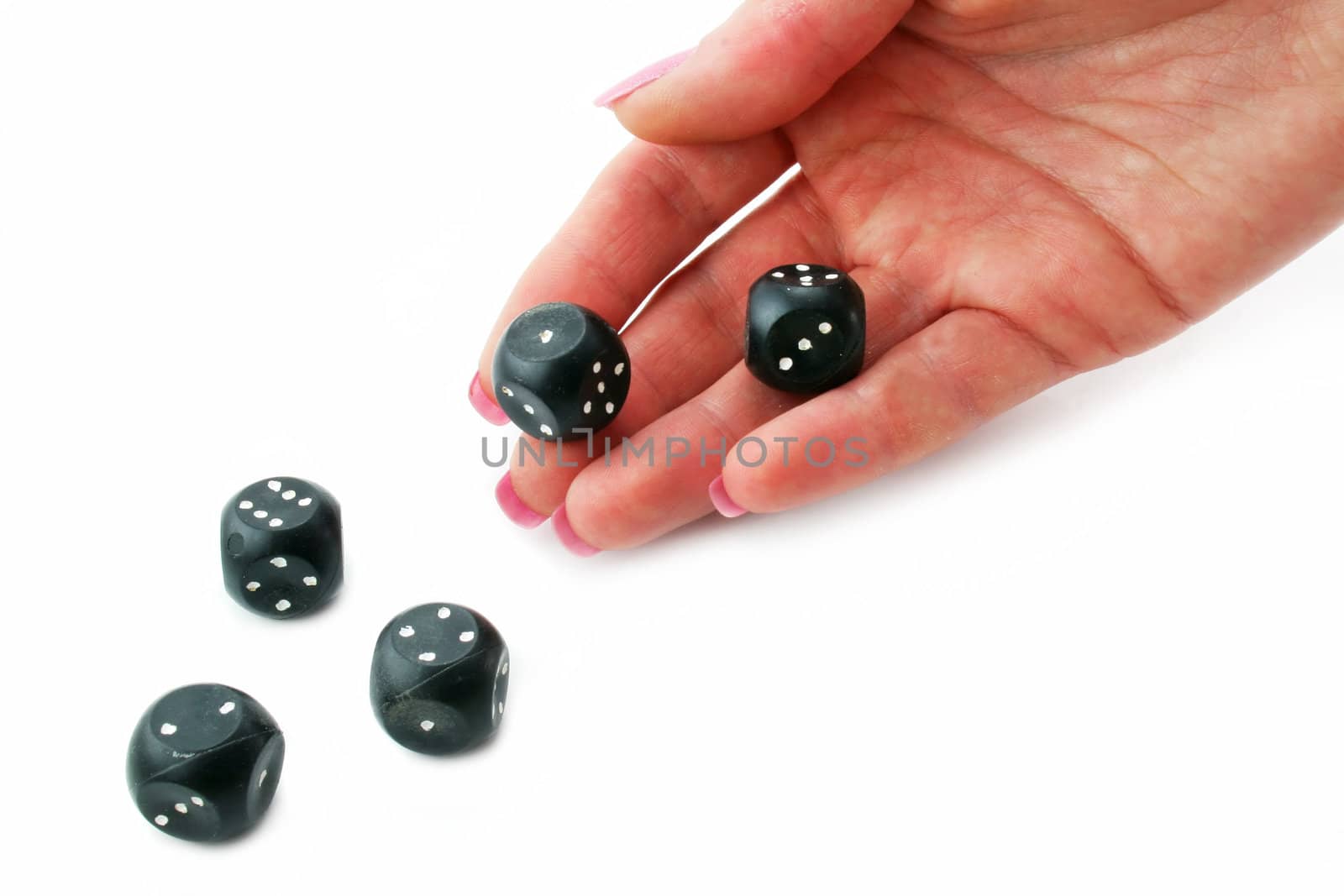 Female hand rolling black dice isolated on a white background