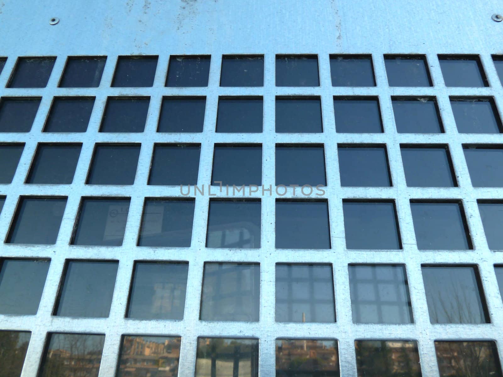 metal grid with reflections in glass