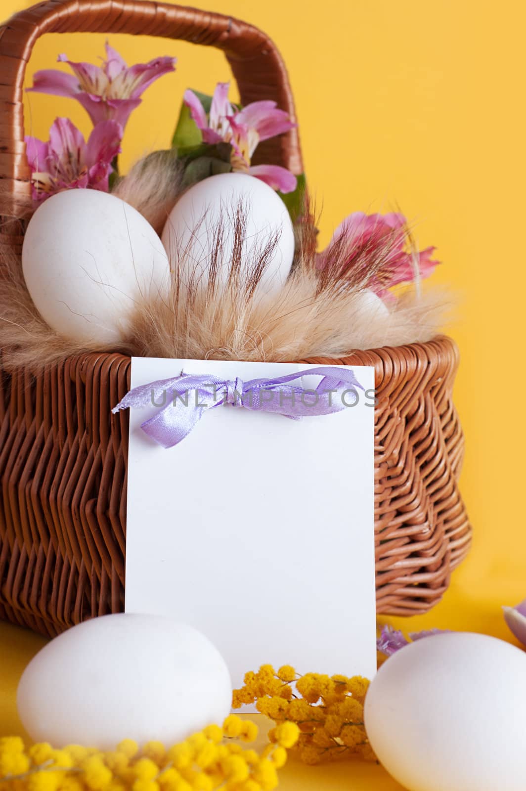 Happy Easter card with basket of eggs and spring flowers