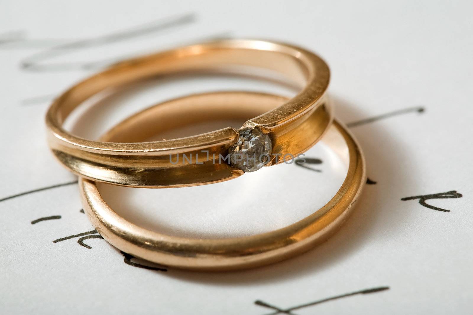 Stock photo: two wedding rings on a letter