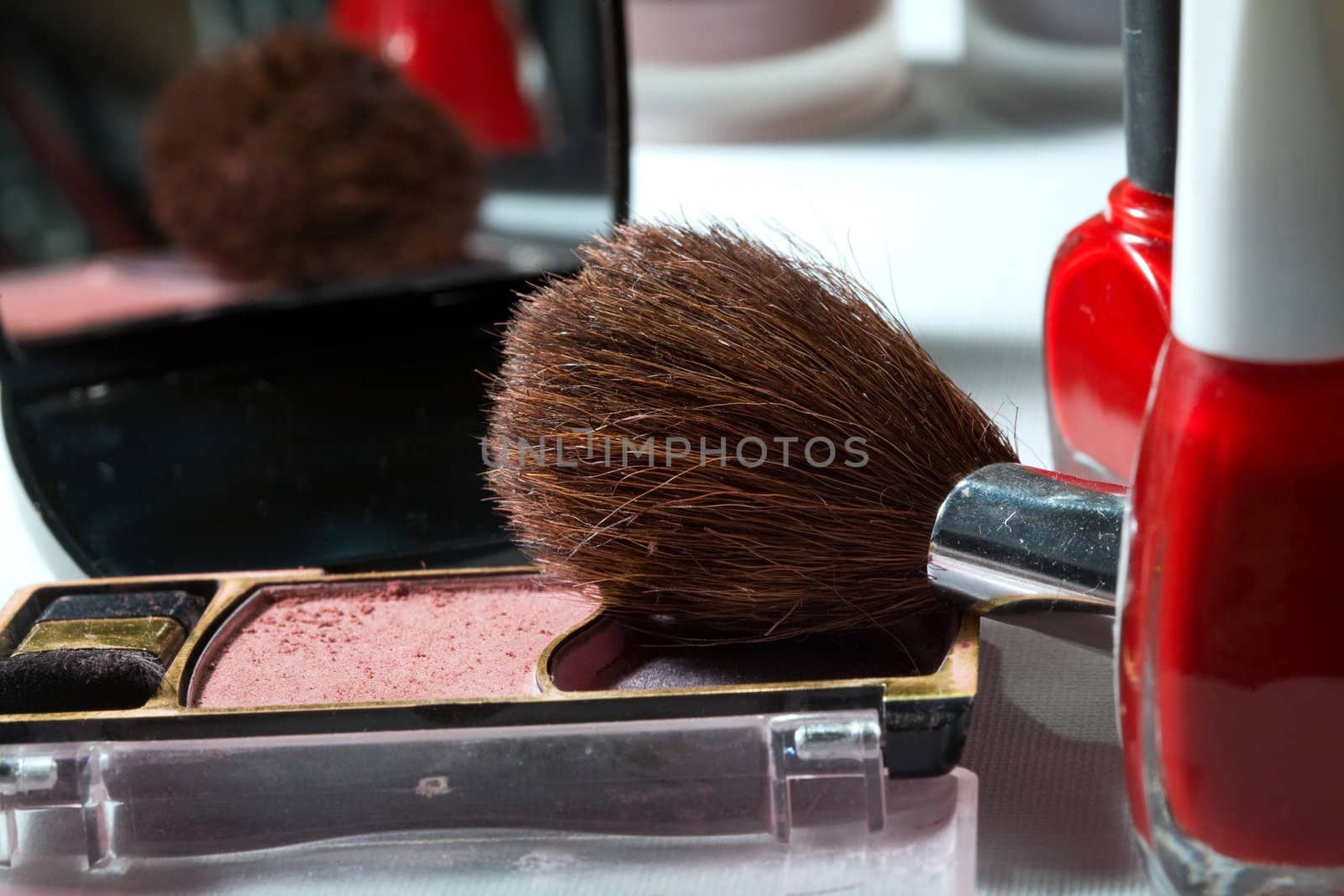 Cosmetic theme: an image of a brush and blush