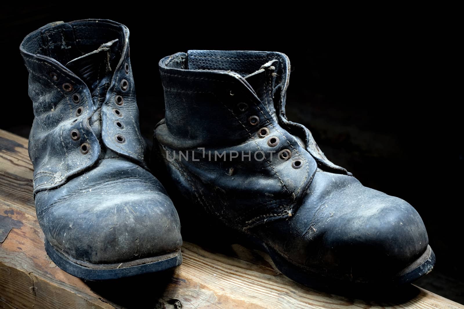 Stock photo: an image of very old black boots closeup