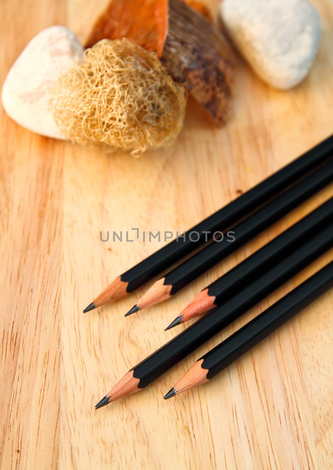 Black pencils on decorated wood background