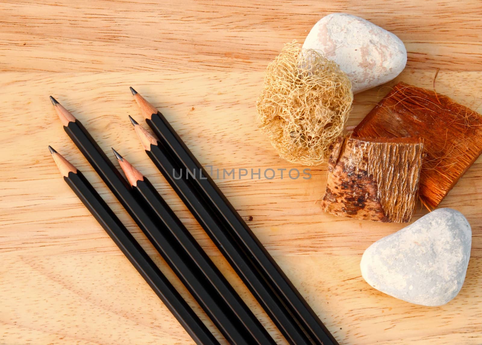 Black pencils on decorated wood background