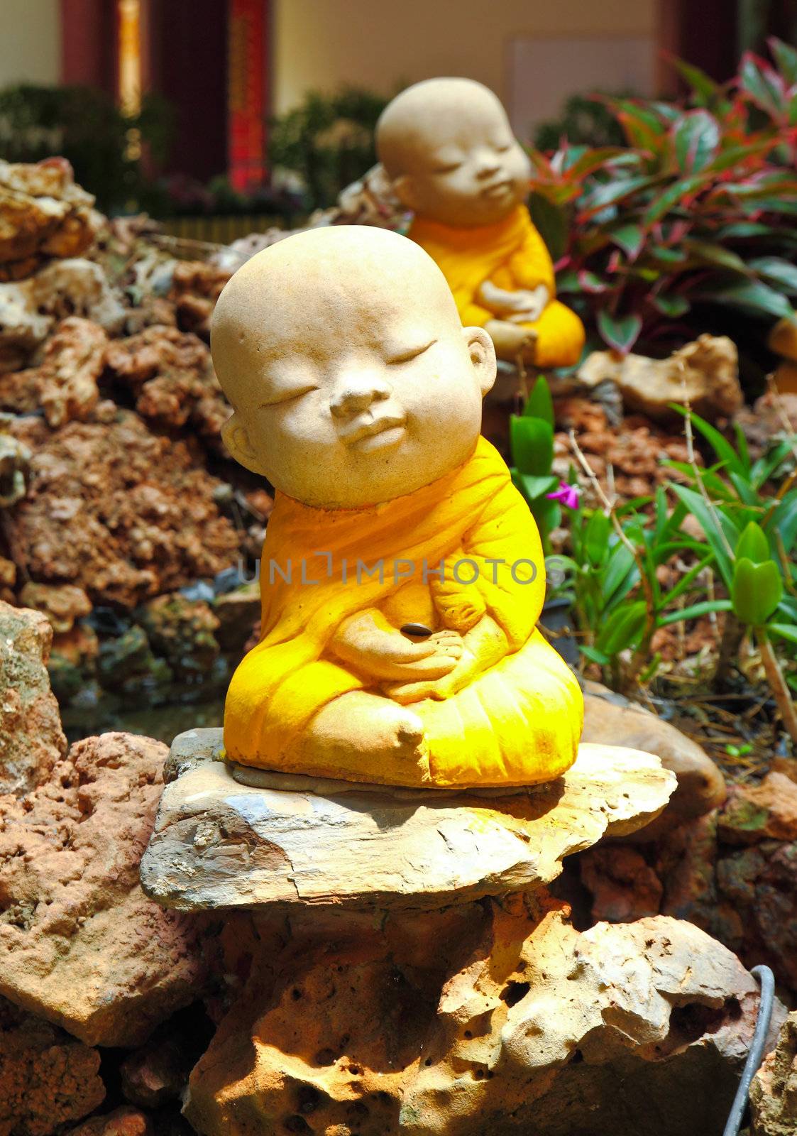Doll clay monk used in ornamental garden in Thailand  by nuchylee