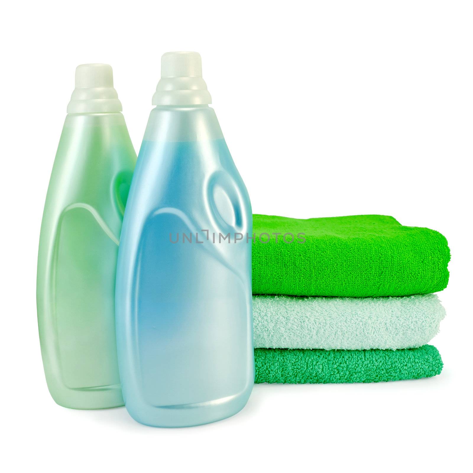 Two bottles of fabric softener blue and green colors, a stack of three towel isolated on white background