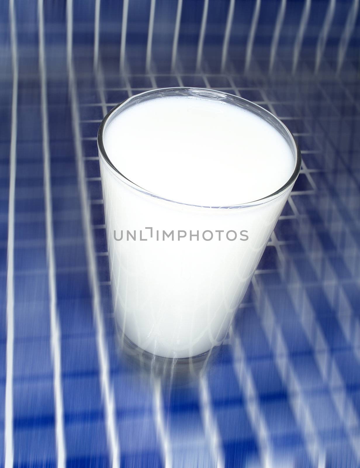 Glass of Milk towards blue mosaic