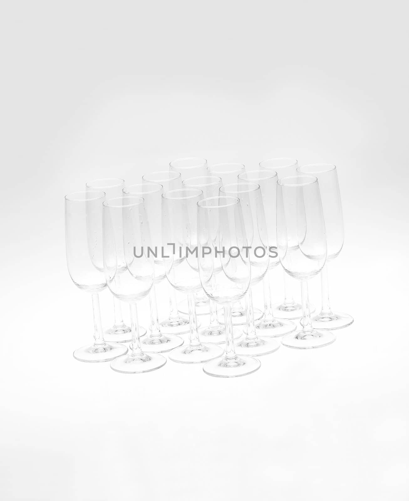 Glasses of champagne on white background