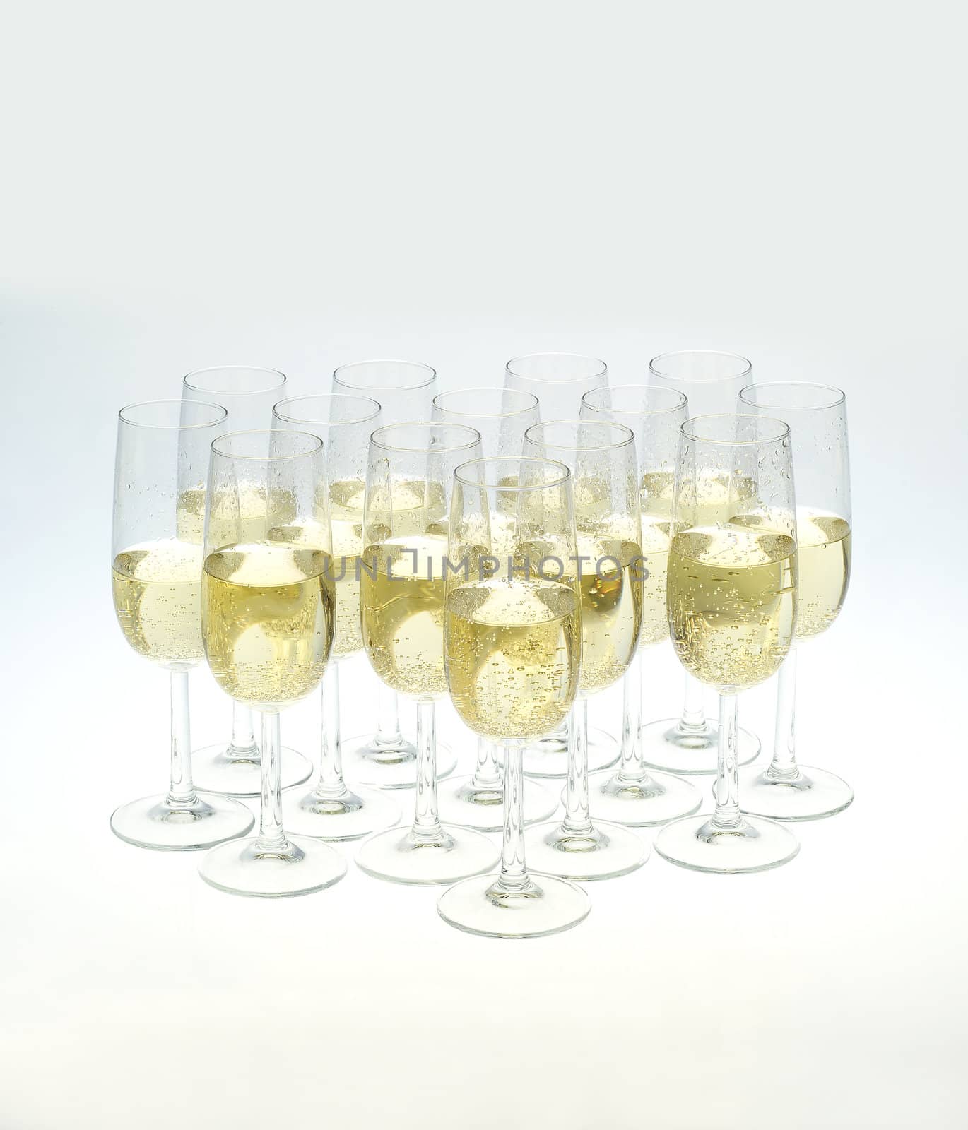 Glasses of champagne on white background