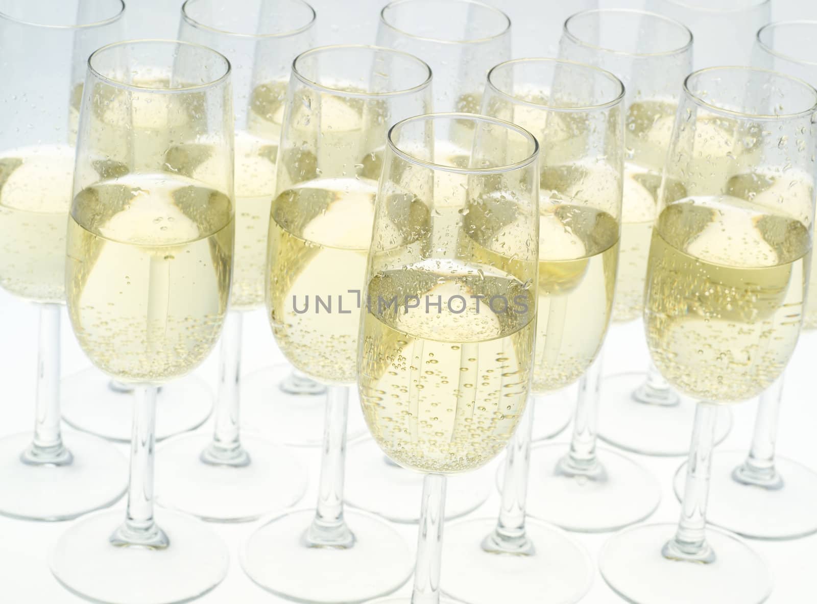 Glasses of champagne on white background