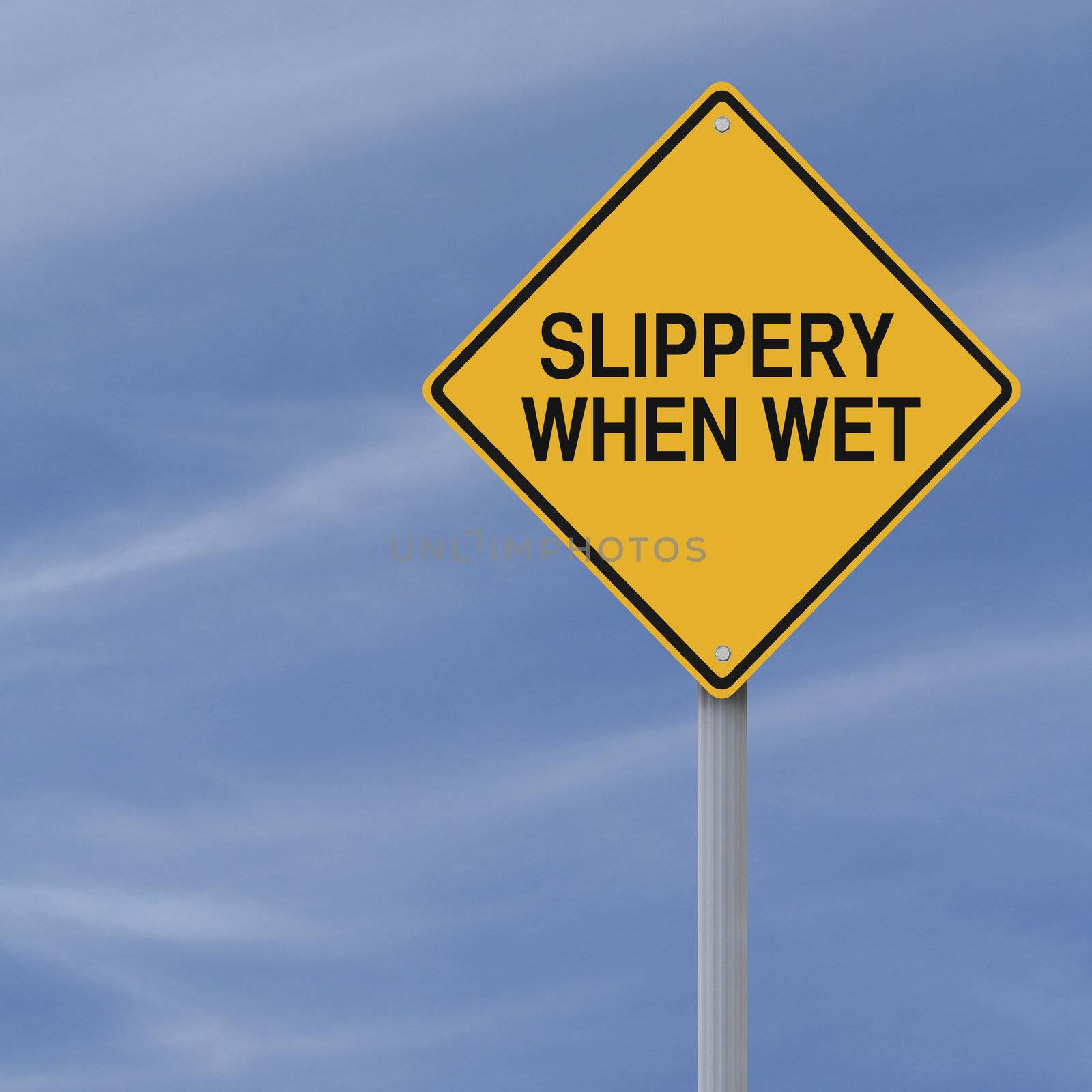 Slippery When Wet road sign against a blue sky background