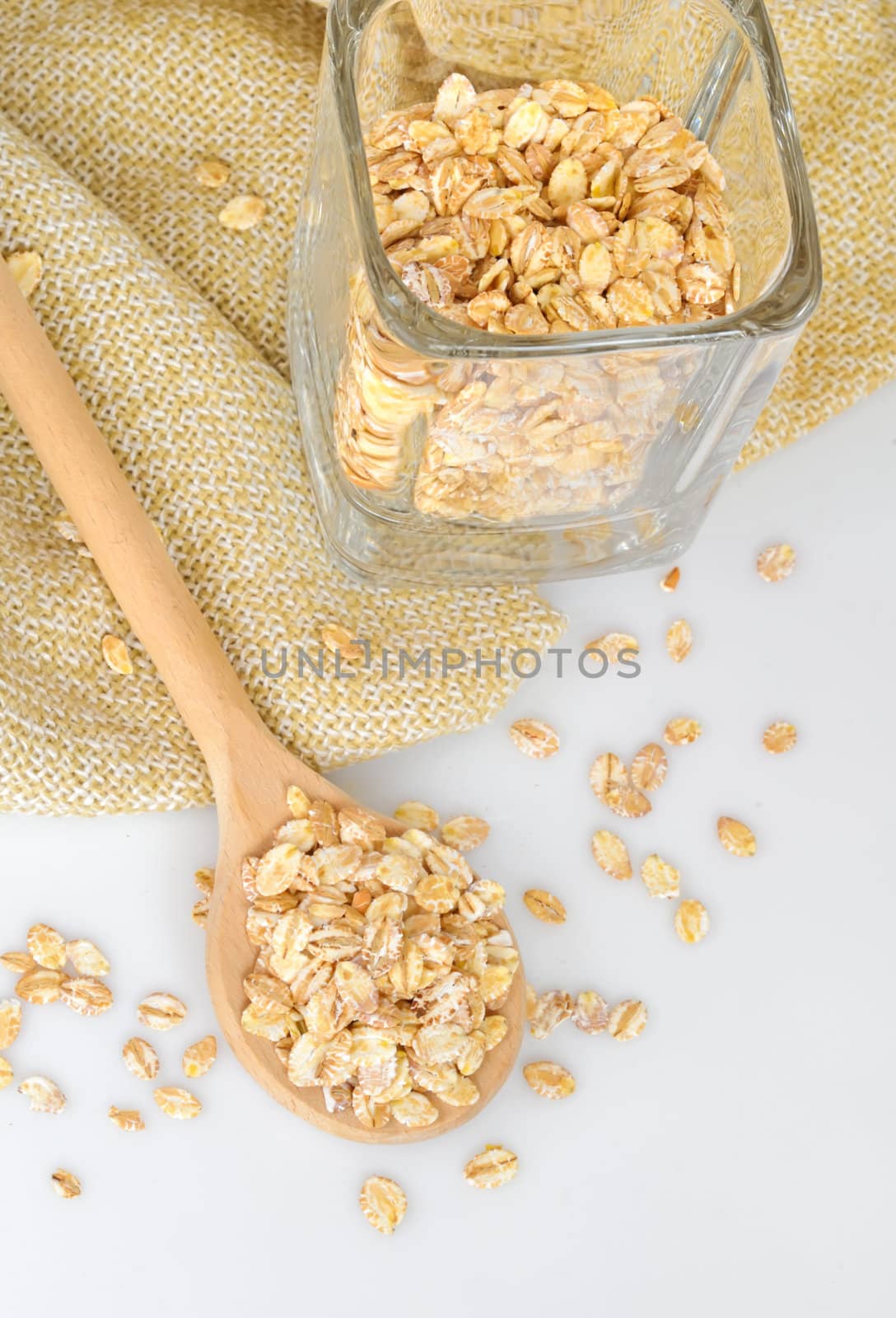 oat-flakes with a wooden spoon  by manaemedia